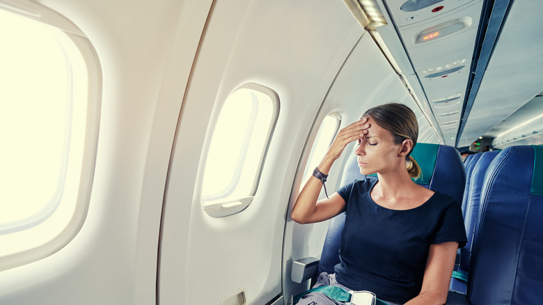 motion sick woman on airplane