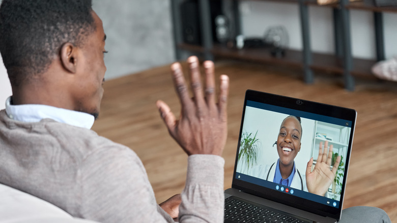 a doctor and patient speaking over a video call