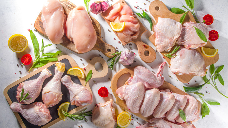 raw chicken portions on wooden boards