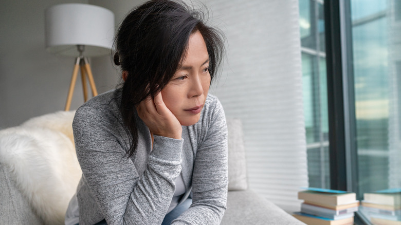 Woman sitting and experiencing anxiety