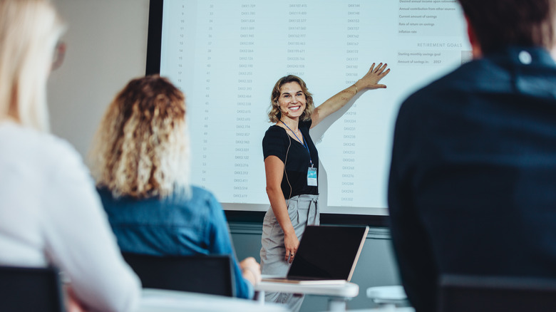 Smiling woman giving presentation