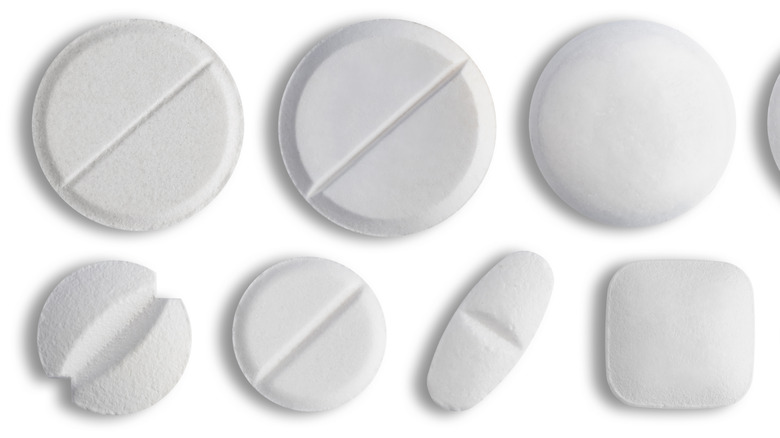 Different sized pills with white background