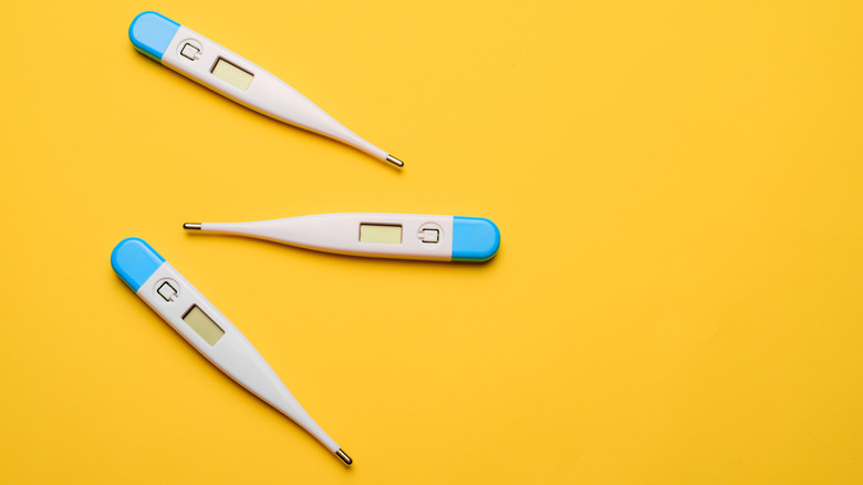 thermometers on yellow background