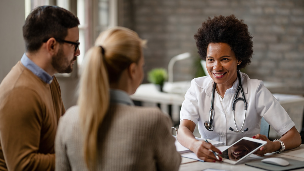 Couple talking to doctor