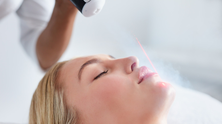 Woman receiving cryotherapy treatment