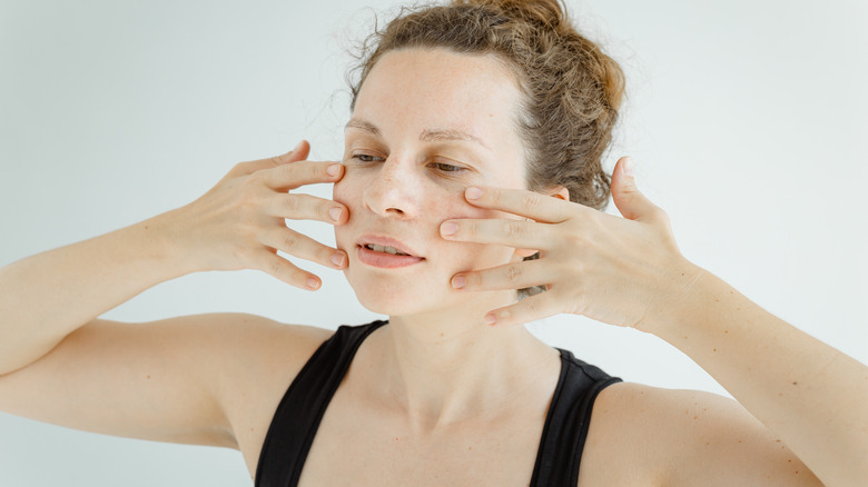 Woman doing face yoga