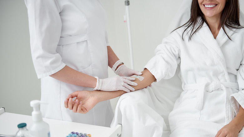 Woman preparing for an IV infusion