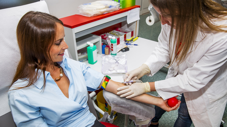 Young woman preparing to donate blood