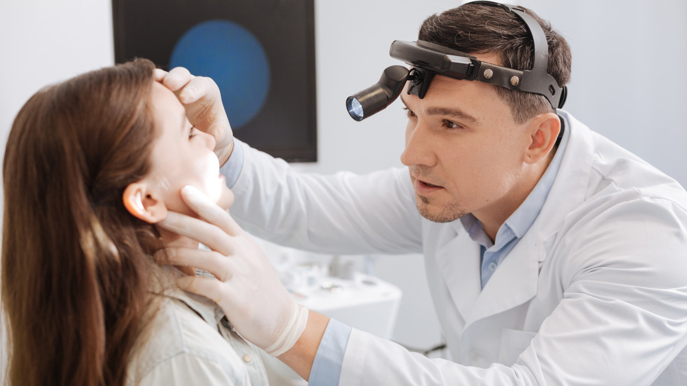 Doctor examining patient's adenoids