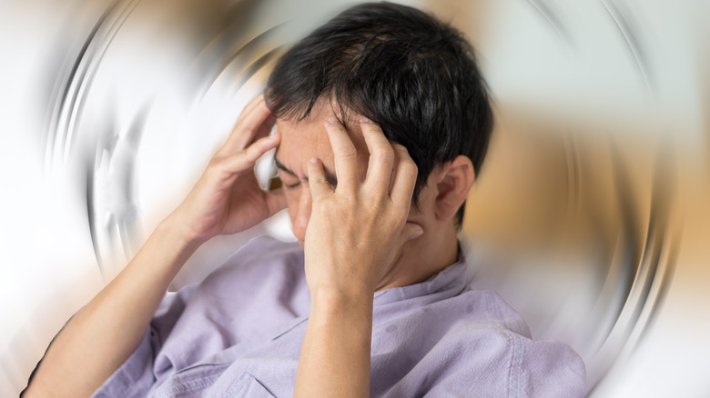 a man holding his head