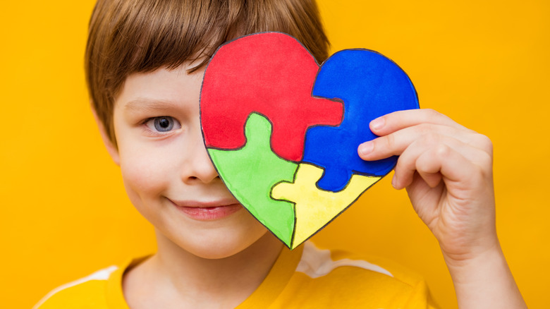 boy with heartshaped puzzle representing autism