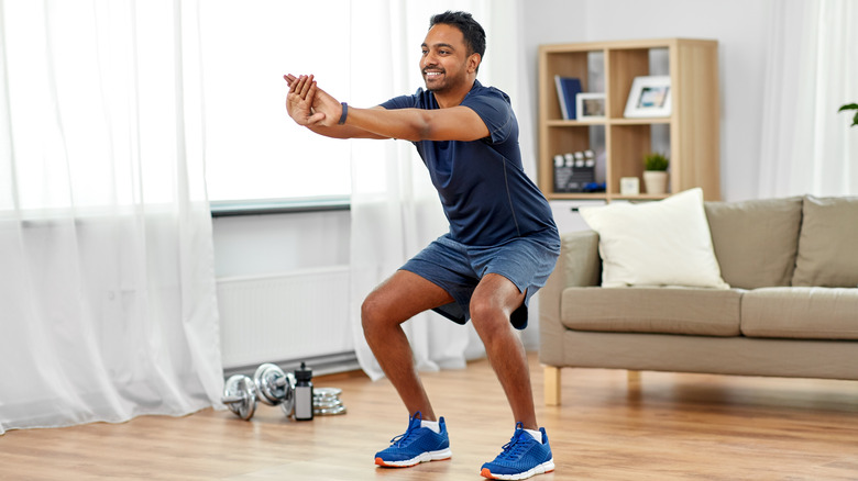 man doing body-weight squats