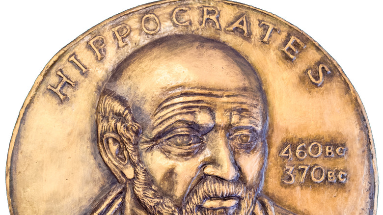 coin with Hippocrates on white background