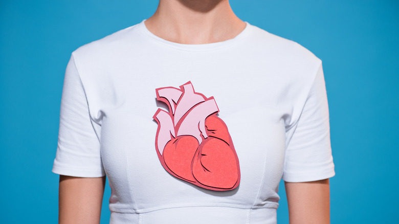 Woman wearing white shirt with cutout of heart