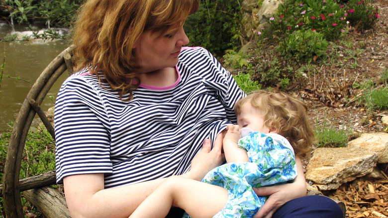 Woman sitting outside nursing child