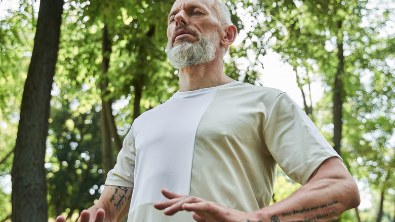 elderly man breathing outdoors