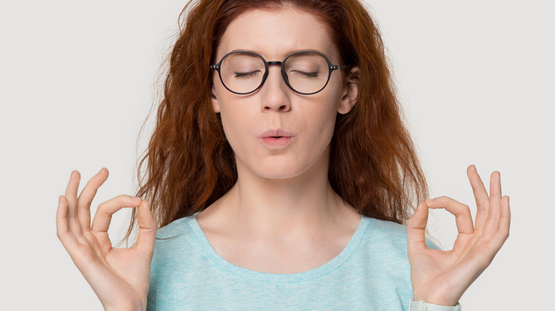 Woman practicing pursed lip breathing 