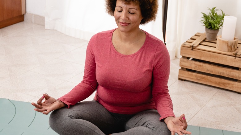 woman sitting doing pranayama at home