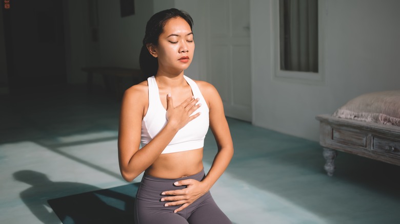 woman doing diaphragmatic breathing