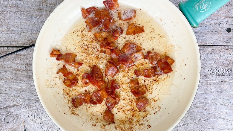 crisped bacon chunks in pan