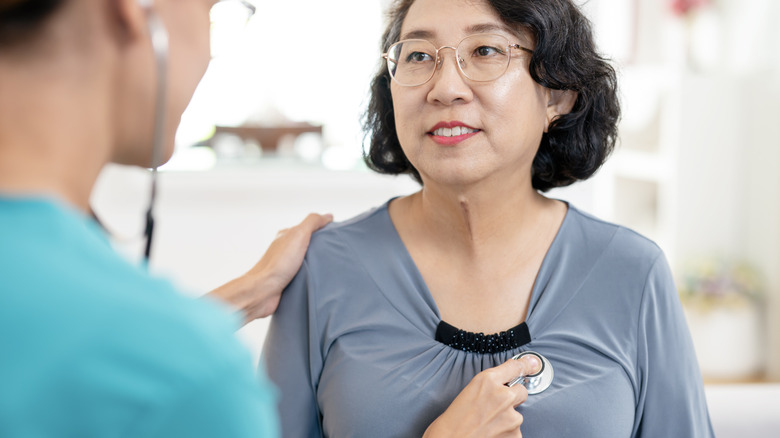 woman having heart examined by medical provider