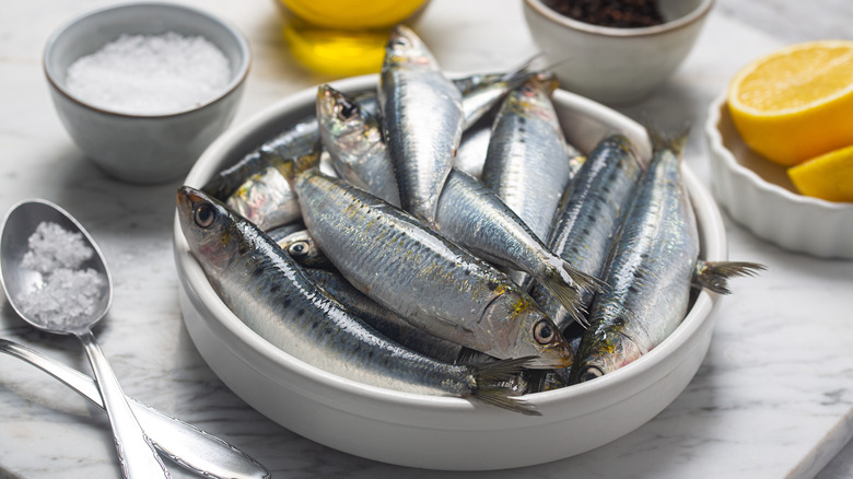 Sardines in bowl with salt and lemon