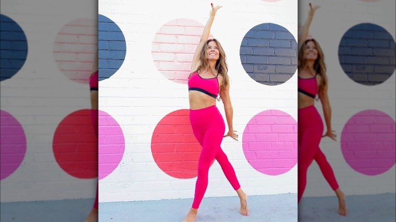 Brooke burke posing in front of polka-dotted wall