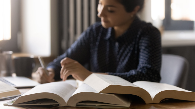 woman studying with books open