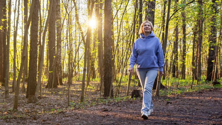 Middle-aged woman walking on nature trail