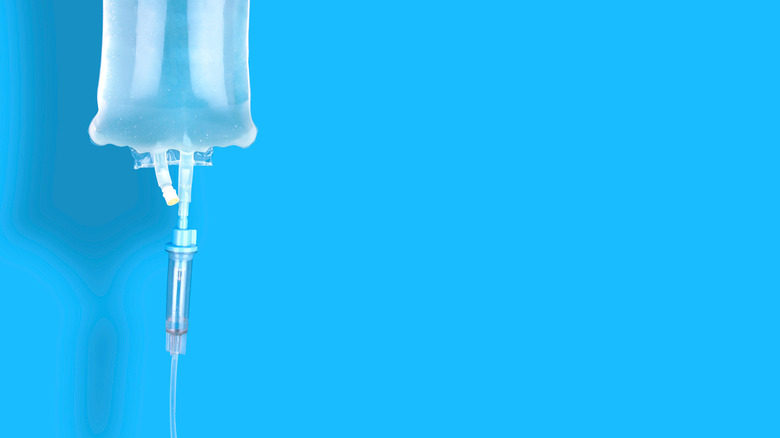 an iv drip against a blue background