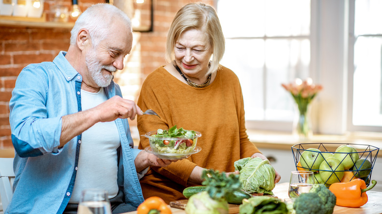 couple making healthy meal in kitchen