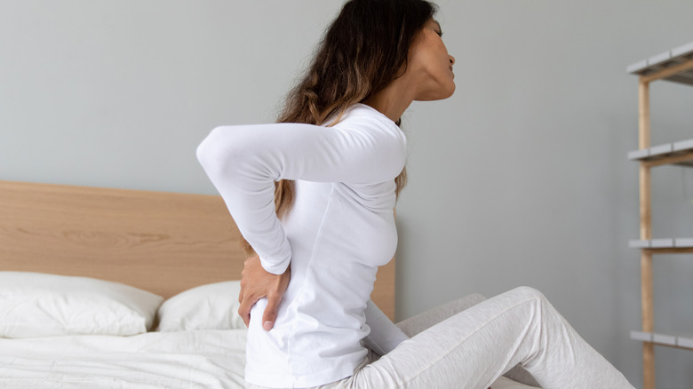 woman holding back in pain
