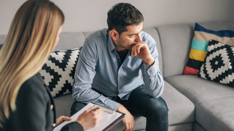 Depressed man speaking to therapist