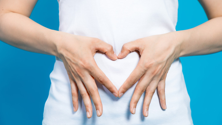 heart-shaped hands on stomach