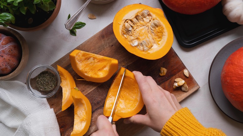 a person slicing pumpkin