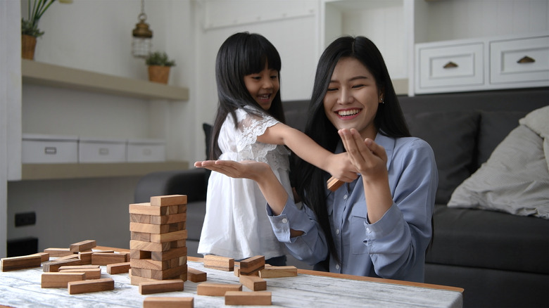 a mom and daughter playing a game together