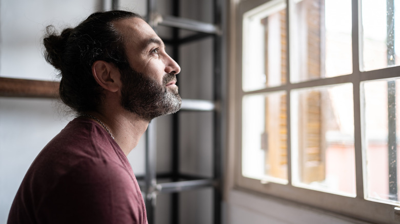 Man looking out the window