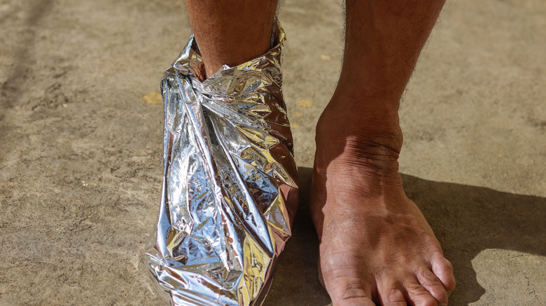 Foot wrapped in aluminum foil