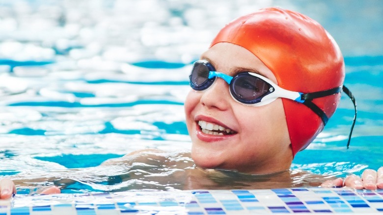 child in pool with swimmer's cap