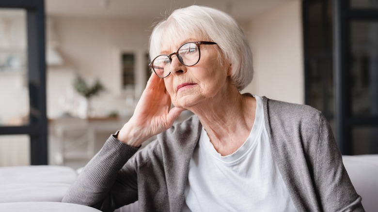 Older woman looking out window