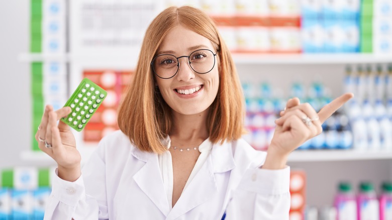 pharmacist holding birth control pills