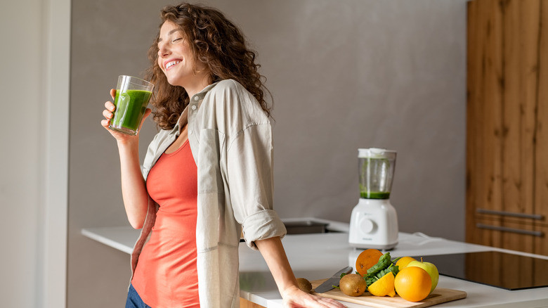 woman drinking a fruit and vegetable smoothie