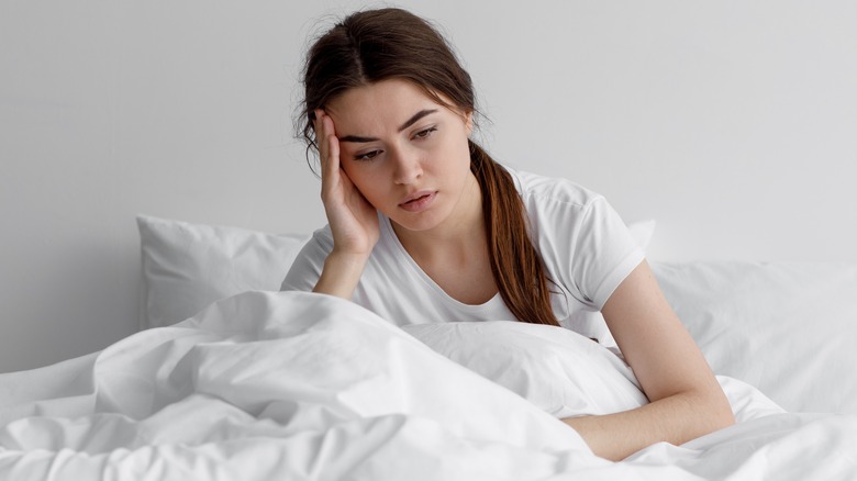 tired woman in bed