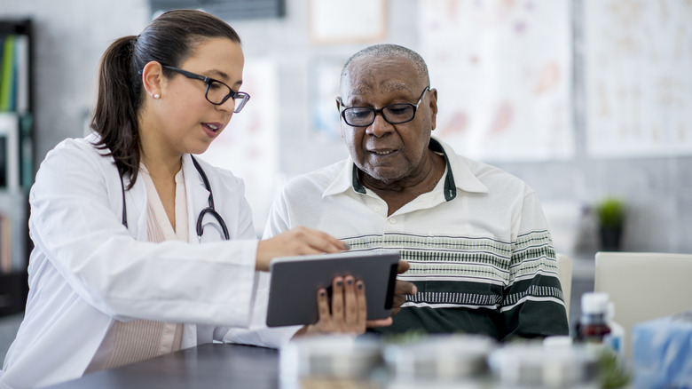 Doctor reviewing chart with patient