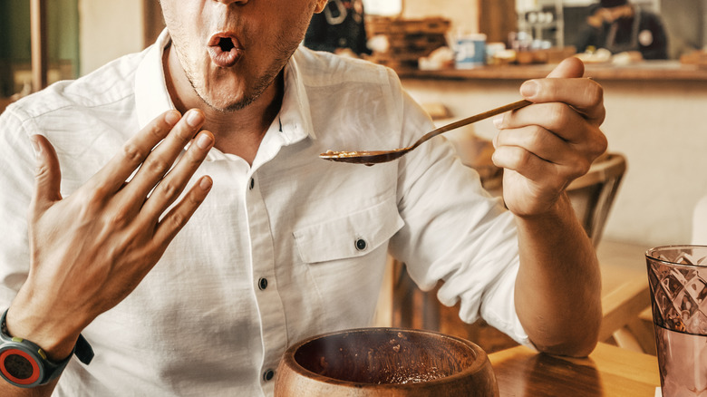 man eating spicy food