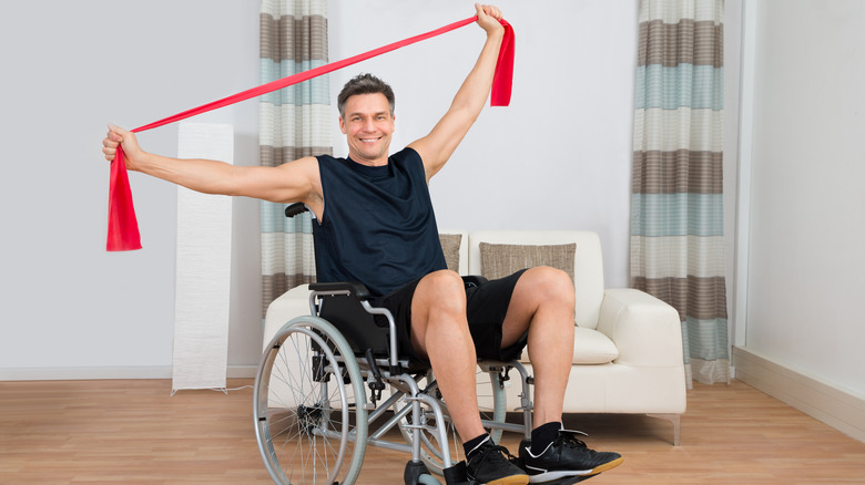 Person in wheelchair with resistance band