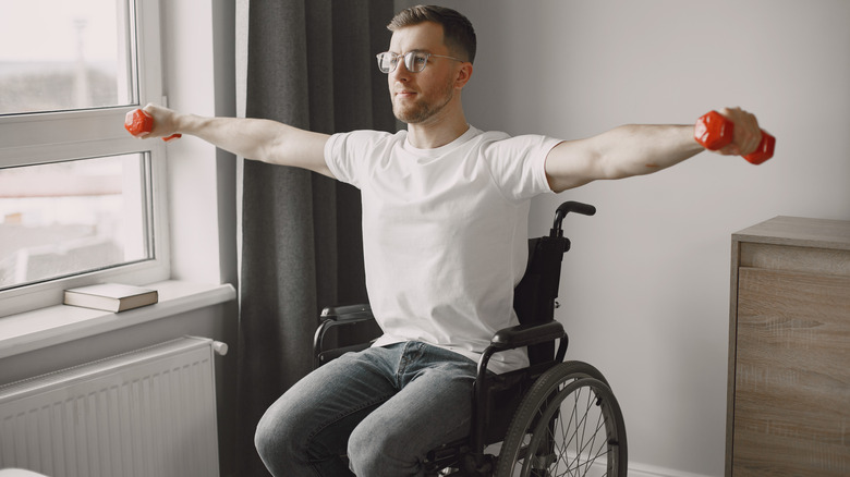 Man in wheelchair with free weights