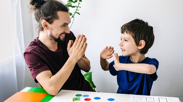 young boy with ADHD interacting with an adult 