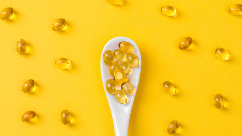 a spoon full of fish oil supplements 