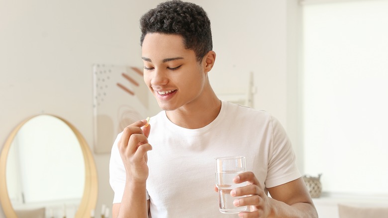 Young person holding supplement